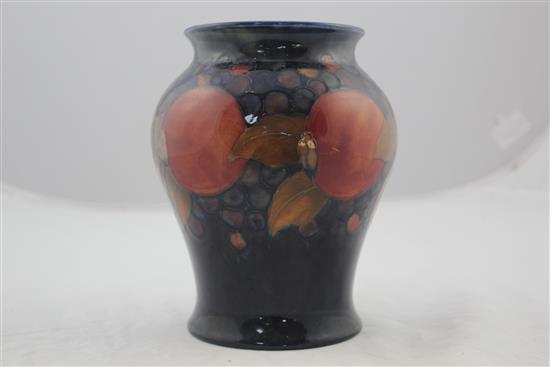 Two William Moorcroft pomegranate pattern vases, c.1916-25, 19cm, latter heavily repaired